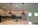 Well-lit kitchen with white cabinets, quartz countertops, and stainless steel appliances at 11884 Richmond Trl, Parrish, FL 34219