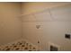 Laundry room with unique tile flooring and shelving at 11884 Richmond Trl, Parrish, FL 34219