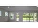 Bright living room with large windows and sliding glass doors that lead to the backyard at 11884 Richmond Trl, Parrish, FL 34219