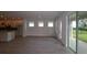 Bright living room with recessed lighting and light wood flooring leading to a kitchen with island at 11884 Richmond Trl, Parrish, FL 34219