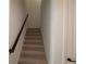 Carpeted staircase with wood banister leading to the upper level of the home at 11884 Richmond Trl, Parrish, FL 34219