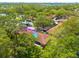 An aerial view shows the roof of the home surrounded by mature trees at 1201 Montrose Pl, Dunedin, FL 34698