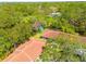 An aerial view of the property with lush greenery, mature trees, and a recreation area nearby at 1201 Montrose Pl, Dunedin, FL 34698