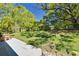 Enjoy the spacious backyard with mature trees and a relaxing patio area at 1201 Montrose Pl, Dunedin, FL 34698