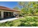 Enjoy this backyard that overlooks the water, has a patio, and beautiful plants at 1201 Montrose Pl, Dunedin, FL 34698