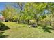 This lush lawn features mature trees and a view of the peaceful lake at 1201 Montrose Pl, Dunedin, FL 34698