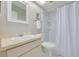 This bathroom features a shower, toilet, vanity, and bright lighting at 1201 Montrose Pl, Dunedin, FL 34698