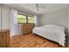 Bedroom featuring wood floors, neutral paint, and a large window with natural light at 1201 Montrose Pl, Dunedin, FL 34698
