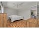 Bedroom with hardwood floors, ceiling fan and a sitting area in the room next door at 1201 Montrose Pl, Dunedin, FL 34698