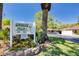 Landscaped Scottsdale Villas I sign with colorful flowers, mature trees and a well-maintained community entrance at 1201 Montrose Pl, Dunedin, FL 34698