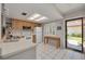 Bright kitchen boasts white appliances, tile floors and a skylight for natural light at 1201 Montrose Pl, Dunedin, FL 34698