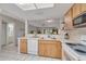 Open-concept kitchen with white appliances and plenty of countertop space at 1201 Montrose Pl, Dunedin, FL 34698