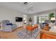 Cozy living room with a ceiling fan, comfortable armchairs and a view to the living area at 1201 Montrose Pl, Dunedin, FL 34698