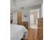 Main bedroom with hardwood floors and adjacent bathroom and closet access at 1201 Montrose Pl, Dunedin, FL 34698