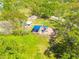 Aerial view of a neighborhood playground with modern equipment and shade, surrounded by lush greenery at 1201 Montrose Pl, Dunedin, FL 34698