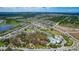 Aerial image showcases a community with homes, green spaces, a pool, and tennis facilities at 12421 Triple Creek Blvd, Riverview, FL 33579