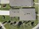 A bird's eye view of a new home shows the roof, yard, driveway, and landscaping at 12421 Triple Creek Blvd, Riverview, FL 33579