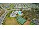 Aerial shot showing neighborhood amenities: clubhouse, pool, and tennis courts at 12421 Triple Creek Blvd, Riverview, FL 33579