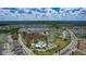 Panoramic aerial view of a Primary-planned community with a pool, tennis courts, and scenic surroundings at 12421 Triple Creek Blvd, Riverview, FL 33579