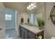 Bathroom vanity featuring granite countertops and decorative plant with wood-look tile floor at 12421 Triple Creek Blvd, Riverview, FL 33579
