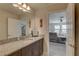 Bathroom with granite vanity, mirror, and open doorway to the bedroom at 12421 Triple Creek Blvd, Riverview, FL 33579