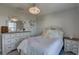 Bedroom featuring white dresser and bedframe, chandelier, and large mirror at 12421 Triple Creek Blvd, Riverview, FL 33579
