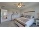 Comfortable bedroom featuring a ceiling fan, dresser, and neutral color scheme at 12421 Triple Creek Blvd, Riverview, FL 33579