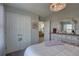 Bedroom featuring white closets, white dresser and bedframe, and view to a living space at 12421 Triple Creek Blvd, Riverview, FL 33579