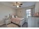 Bedroom with neutral tones, ceiling fan, and natural light from window at 12421 Triple Creek Blvd, Riverview, FL 33579
