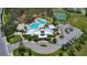 Aerial photo of a community pool, clubhouse, and tennis courts in a landscaped setting at 12421 Triple Creek Blvd, Riverview, FL 33579