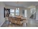 Inviting dining area with a long wooden table and seating for six, steps away from the home's entry at 12421 Triple Creek Blvd, Riverview, FL 33579