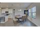 Well-lit dining area featuring a large table with seating for eight, complemented by a modern kitchen at 12421 Triple Creek Blvd, Riverview, FL 33579