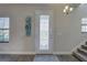 Bright entryway featuring a decorative shelf, glass front door, and wood-look floors at 12421 Triple Creek Blvd, Riverview, FL 33579