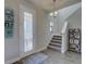 Inviting entryway featuring stylish decor, a glass front door, and a staircase at 12421 Triple Creek Blvd, Riverview, FL 33579