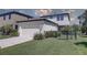 Two story home with fenced yard, a front lawn, and a two car garage at 12421 Triple Creek Blvd, Riverview, FL 33579