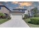 Two story home with fenced yard, a front lawn, and a two car garage at 12421 Triple Creek Blvd, Riverview, FL 33579