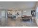Bright open kitchen and dining area featuring white cabinets, a spacious island, and modern pendant lighting at 12421 Triple Creek Blvd, Riverview, FL 33579