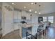 Stylish kitchen island featuring a breakfast bar, granite countertops, pendant lights, and stainless steel appliances at 12421 Triple Creek Blvd, Riverview, FL 33579
