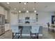 Modern kitchen with breakfast bar seating, stainless appliances, granite countertops, and pendant lighting at 12421 Triple Creek Blvd, Riverview, FL 33579