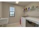 Bright laundry room with modern appliances, shelving, and a window for natural light at 12421 Triple Creek Blvd, Riverview, FL 33579