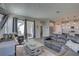 Open-concept living room featuring a plush sofa, stylish décor, and sliding doors to the outdoor space at 12421 Triple Creek Blvd, Riverview, FL 33579
