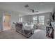 Living room featuring a comfortable sofa near bright windows and a stylish console table at 12421 Triple Creek Blvd, Riverview, FL 33579