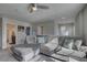 Living room featuring a large gray sectional couch, creating a cozy and inviting atmosphere at 12421 Triple Creek Blvd, Riverview, FL 33579