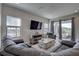 Open living room features a large sectional sofa, stylish coffee table, and backyard access at 12421 Triple Creek Blvd, Riverview, FL 33579