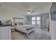Bedroom with a large window, ceiling fan, and light gray color palette at 12421 Triple Creek Blvd, Riverview, FL 33579
