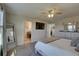 Bedroom with large mirror, TV, ceiling fan and ensuite bathroom at 12421 Triple Creek Blvd, Riverview, FL 33579