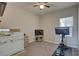 A well lit home office with blinds on the windows, a ceiling fan, and carpet flooring at 12421 Triple Creek Blvd, Riverview, FL 33579
