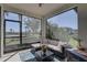 Screened in patio features outdoor couch, rug, coffee table, and views of the backyard at 12421 Triple Creek Blvd, Riverview, FL 33579