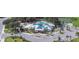 Stunning aerial view of the community clubhouse, pool, tennis courts, and playground with lush landscaping at 12957 Wildflower Meadow Dr, Riverview, FL 33579