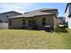 Backyard of home featuring a lawn and exterior of home at 12957 Wildflower Meadow Dr, Riverview, FL 33579